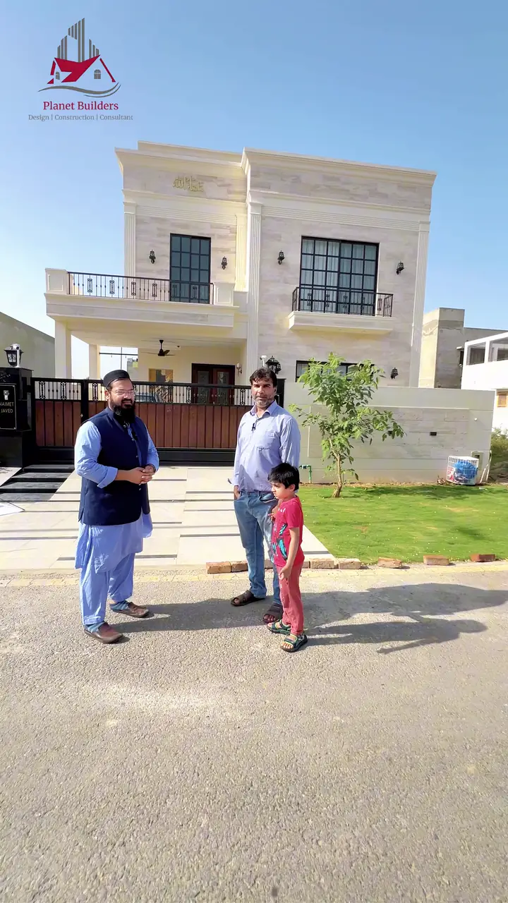 Planet Builders client with his family outside their completed DHA Phase 7, T Block home